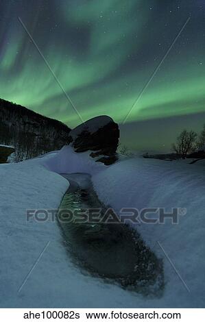Aurora Borealis over a frozen river, Norway. View Large Photo Image Stock Photograph - Aurora Borealis over a frozen river, Norway.. Fotosearch