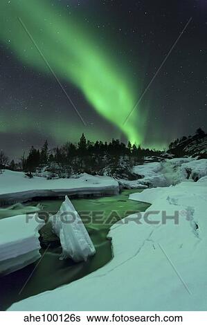 Aurora Borealis over a frozen Tennevik River, Troms, Norway. View Large Photo Image Stock Photograph - Aurora Borealis over a frozen Tennevik River, Troms, Norway.. Fotosearch