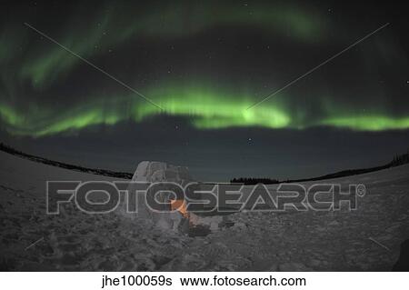 Aurora borealis over an igloo on Walsh Lake, Canada. View Large Photo Image Stock Photograph - Aurora borealis over an igloo on Walsh Lake, Canada.. Fotosearch
