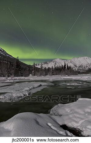 Stock Photograph - Aurora borealis over Annie Lake, Yukon, Canada.. Fotosearch
