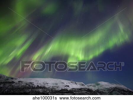 Stock Photograph - Aurora borealis over Blafjellet Mountain in Troms County, Norway.. Fotosearch