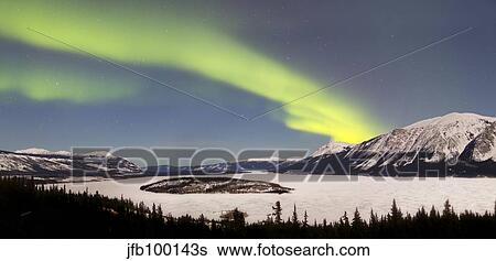 Stock Photograph - Aurora borealis over Bove Island, Yukon, Canada.. Fotosearch