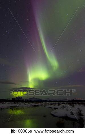 Stock Photograph - Aurora borealis over creek by Fish Lake, Whitehorse, Yukon, Canada.. Fotosearch