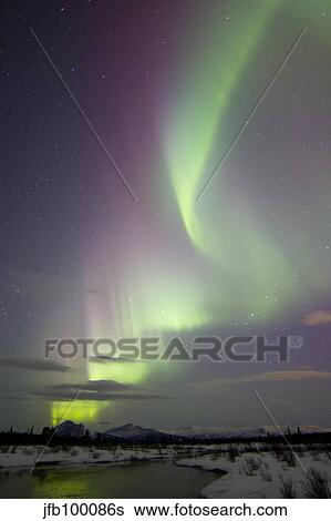 Stock Photograph - Aurora borealis over creek by Fish Lake, Whitehorse, Yukon, Canada.. Fotosearch