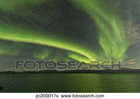 Stock Photograph - Aurora borealis over Fish Lake, Yukon, Canada.. Fotosearch
