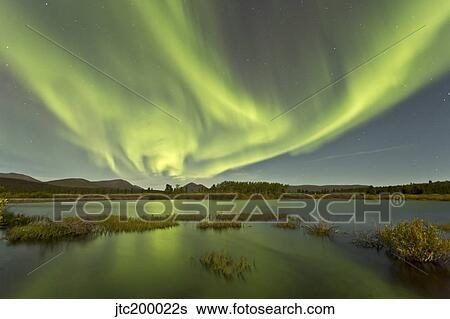 Stock Photograph - Aurora borealis over Fish Lake, Yukon, Canada.. Fotosearch