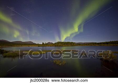 Aurora borealis over Fish Lake, Yukon, Canada. View Large Photo Image Stock Photograph - Aurora borealis over Fish Lake, Yukon, Canada.. Fotosearch