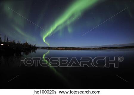 Stock Photograph - Aurora borealis over Long Lake, Northwest Territories, Canada.. Fotosearch
