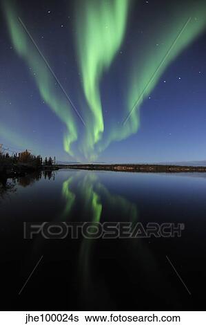Stock Photograph - Aurora borealis over Long Lake, Northwest Territories, Canada.. Fotosearch