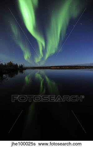 Stock Photograph - Aurora borealis over Long Lake, Northwest Territories, Canada.. Fotosearch