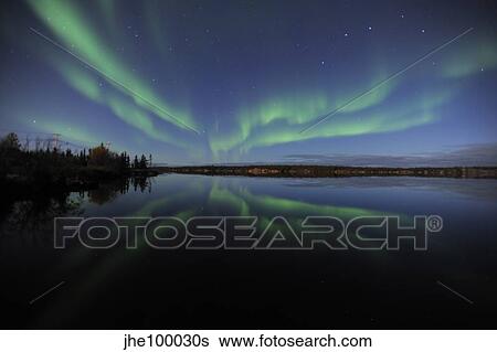 Stock Photograph - Aurora borealis over Long Lake, Northwest Territories, Canada.. Fotosearch