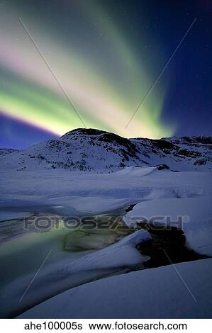 Stock Photograph - Aurora Borealis over Mikkelfjellet Mountain in Troms County, Norway.. Fotosearch