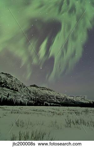 Aurora borealis over mountain, Annie Lake, Yukon, Canada. View Large Photo Image Stock Photograph - Aurora borealis over mountain, Annie Lake, Yukon, Canada.. Fotosearch