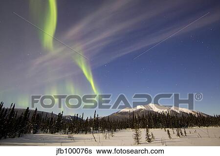 Aurora borealis over mountain near Mayo, Yukon, Canada. View Large Photo Image Stock Photograph - Aurora borealis over mountain near Mayo, Yukon, Canada.. Fotosearch