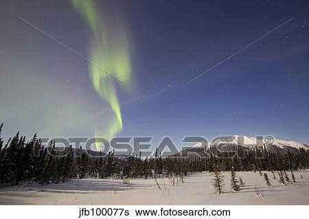 Aurora borealis over mountain near Mayo, Yukon, Canada. View Large Photo Image Stock Photograph - Aurora borealis over mountain near Mayo, Yukon, Canada.. Fotosearch