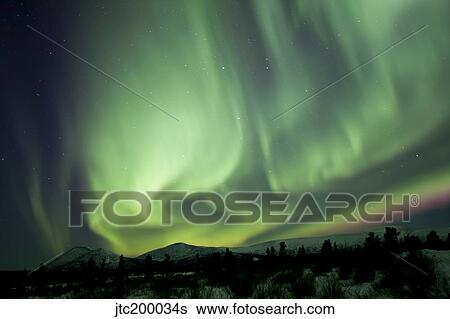 Aurora borealis over mountain, Yukon, Canada. View Large Photo Image Stock Photograph - Aurora borealis over mountain, Yukon, Canada.. Fotosearch