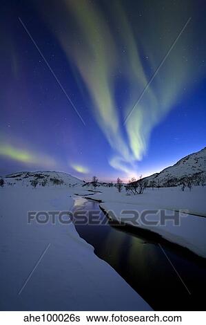 Stock Photograph - Aurora Borealis over Skittendalen Valley, Troms County, Norway.. Fotosearch