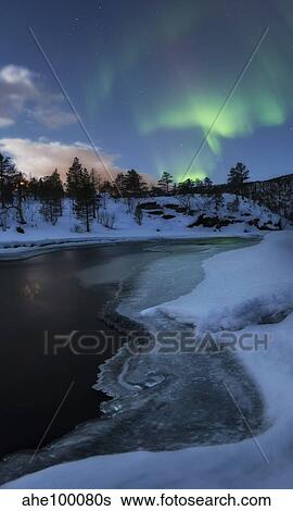 Stock Photograph - Aurora Borealis over Tennevik River, Troms, Norway.. Fotosearch