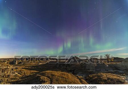 Stock Photograph - Aurora borealis over the badlands of Dinosaur Provincial Park, Canada.. Fotosearch