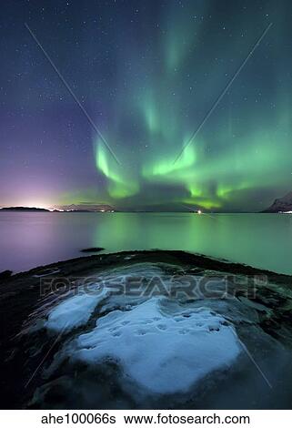 Stock Photograph - Aurora Borealis over Vagsfjorden outside of Harstad in Northern Norway.. Fotosearch