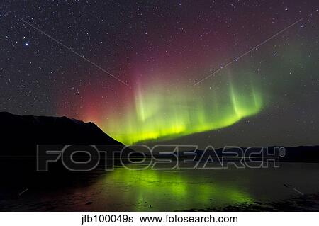 Stock Photograph - Aurora borealis with Big Dipper over Kluane Lake, Yukon, Canada.. Fotosearch
