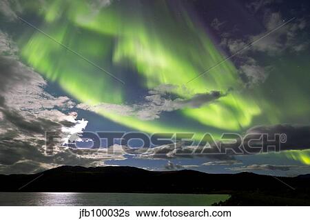 Aurora borealis with moonlight at Fish Lake, Yukon, Canada. View Large Photo Image Stock Photograph - Aurora borealis with moonlight at Fish Lake, Yukon, Canada.. Fotosearch