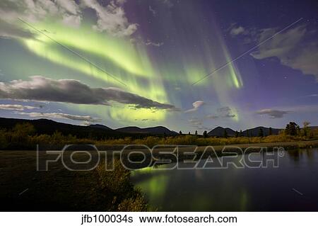 Aurora borealis with moonlight at Fish Lake, Yukon, Canada. View Large Photo Image Stock Photograph - Aurora borealis with moonlight at Fish Lake, Yukon, Canada.. Fotosearch