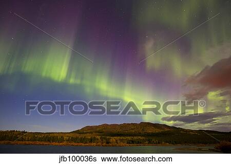 Aurora borealis with moonlight at Fish Lake, Yukon, Canada. View Large Photo Image Stock Photograph - Aurora borealis with moonlight at Fish Lake, Yukon, Canada.. Fotosearch