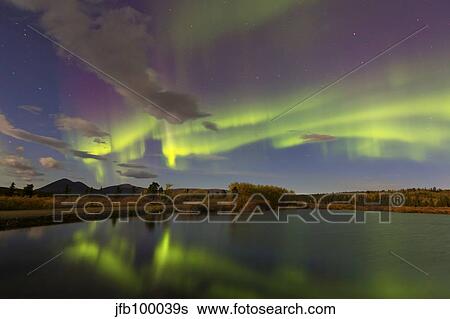 Aurora borealis with moonlight at Fish Lake, Yukon, Canada. View Large Photo Image Stock Photograph - Aurora borealis with moonlight at Fish Lake, Yukon, Canada.. Fotosearch