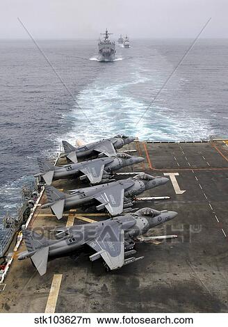 AV-8B Harriers line the flight deck of amphibious assault ship USS Tarawa. View Large Photo Image Picture - AV-8B Harriers line the flight deck of amphibious assault ship USS Tarawa.. Fotosearch