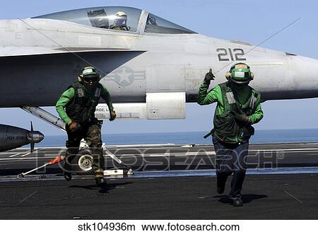 Picture - Aviation Boatswain Mate's signal a clear flight deck aboard USS John C. Stennis.. Fotosearch
