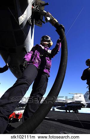 Aviation Boatswain's Mate Airman fuels an aircraft. View Large Photo Image Picture - Aviation Boatswain's Mate Airman fuels an aircraft.. Fotosearch
