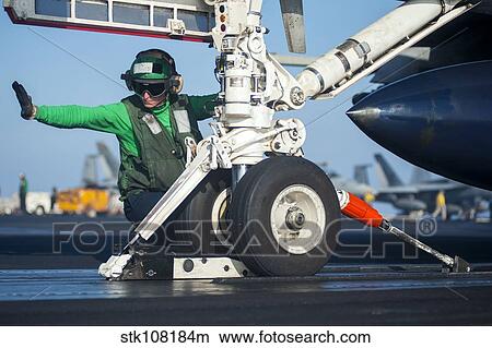 Aviation Boatswain's Mate attaches an F/A-18F Super Hornet to the catapult. View Large Photo Image Picture - Aviation Boatswain's Mate attaches an F/A-18F Super Hornet to the catapult.. Fotosearch