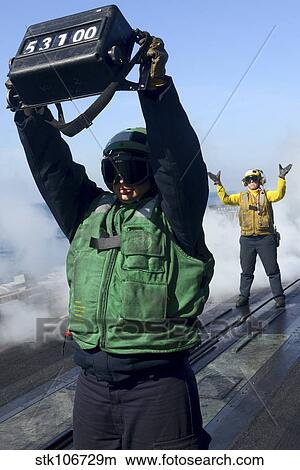 Aviation Boatswain's Mate confirms an aircraft's weight. View Large Photo Image Picture - Aviation Boatswain's Mate confirms an aircraft's weight.. Fotosearch