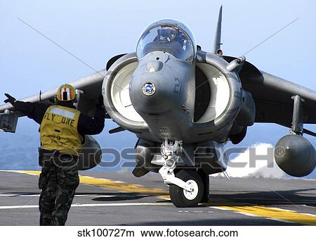 Aviation Boatswain's Mate directs an AV-8B Harrier. View Large Photo Image Picture - Aviation Boatswain's Mate directs an AV-8B Harrier.. Fotosearch