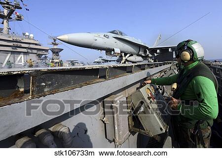 Aviation Boatswain's Mate launches an F/A-18C Hornet from USS John C. Stennis. View Large Photo Image Picture - Aviation Boatswain's Mate launches an F/A-18C Hornet from USS John C. Stennis.. Fotosearch