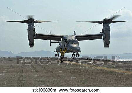 Aviation Boatswain's Mate signals an MV-22 Osprey as it takes off. View Large Photo Image Picture - Aviation Boatswain's Mate signals an MV-22 Osprey as it takes off.. Fotosearch