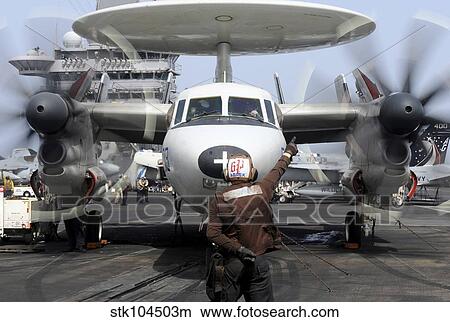 Aviation Electronics Technician directs an E-2C Hawkeye to start its engines. View Large Photo Image Picture - Aviation Electronics Technician directs an E-2C Hawkeye to start its engines.. Fotosearch
