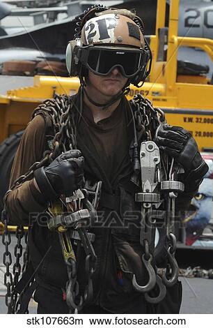 Aviation Machinist's Mate carrying chains. View Large Photo Image Picture - Aviation Machinist's Mate carrying chains.. Fotosearch