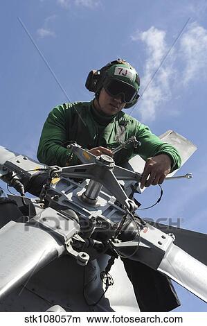 Aviation Machinist's Mate performs maintenance on an MH-60R Seahawk. View Large Photo Image Picture - Aviation Machinist's Mate performs maintenance on an MH-60R Seahawk.. Fotosearch