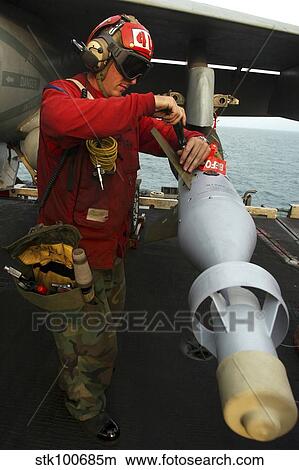 Aviation Ordnanceman attaches a stabilizer fin to a GBU-16 1000 pound laser-guided bomb. View Large Photo Image Picture - Aviation Ordnanceman attaches a stabilizer fin to a GBU-16 1000 pound laser-guided bomb.. Fotosearch