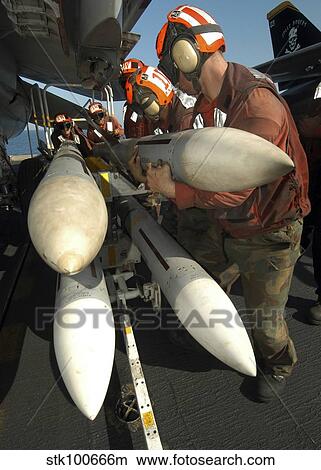 Aviation Ordnancemen load AIM-7 Sparrow air-to-air missiles on an F-14B Tomcat. View Large Photo Image Picture - Aviation Ordnancemen load AIM-7 Sparrow air-to-air missiles on an F-14B Tomcat.. Fotosearch