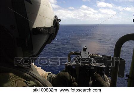 Picture - Aviation Warfare Systems Operator fires a. 50 caliber machine gun.. Fotosearch