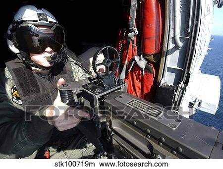 Aviation Warfare Systems Operator mans a. 50 caliber machine gun. View Large Photo Image Picture - Aviation Warfare Systems Operator mans a. 50 caliber machine gun.. Fotosearch