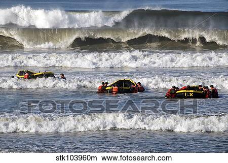 Picture - Basic Underwater Demolition/SEAL students participate in a surf passage training exercise.. Fotosearch