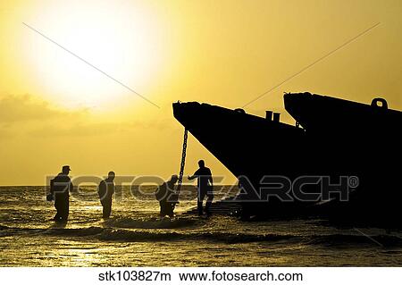 Beach masters assist Sailors and Marines onto a landing craft utility in Port-de-Paix, Haiti. View Large Photo Image Picture - Beach masters assist Sailors and Marines onto a landing craft utility in Port-de-Paix, Haiti.. Fotosearch