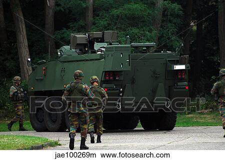 Belgian Infantry soldiers walk alongside the Piranha IIC armoured infantry vehicle. View Large Photo Image Picture - Belgian Infantry soldiers walk alongside the Piranha IIC armoured infantry vehicle.. Fotosearch