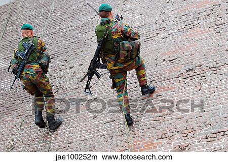 Belgian paratroopers climbing a wall during Operation Storm Tide. View Large Photo Image Picture - Belgian paratroopers climbing a wall during Operation Storm Tide.. Fotosearch