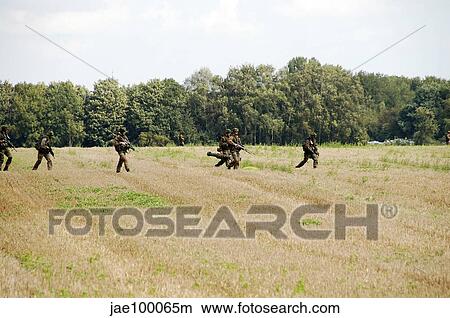 Picture - Belgian paratroopers proceeding in the fields.. Fotosearch