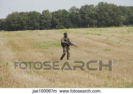 Picture - Belgian paratroopers proceeding in the fields.. Fotosearch